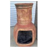 Traditional rustic clay chiminea, used as a