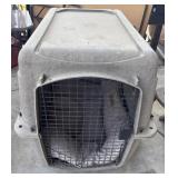Heavy-duty plastic pet crate.