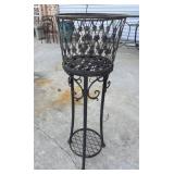 Vintage-style black metal basket plant stand.