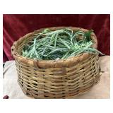 Hand woven wooden wicker basket with long, green