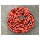coiled red outdoor extension cord, medium-duty