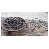 2 Round metal plant stands featuring an ornate