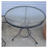 Round glass-top patio table.