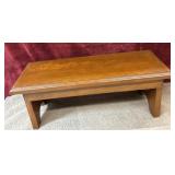 small, rectangular wooden bench