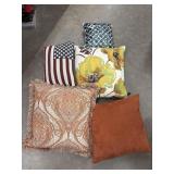 Collection of decorative throw pillows, including