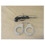 Derringer pistol lighter and Imperial hand cuffs
