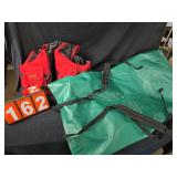 Cabellas life jacket and green dry bag