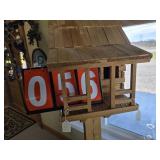 cabin birdhouse on post