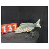 Metal fish has hangers on top of it over 12'