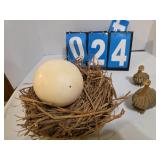 ostrich egg and nest plus a couple little figures