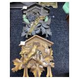 Two Carved Wood Cuckoo Clocks with Leaf Motifs