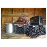 Crates, tarp, water hose, metal cooker