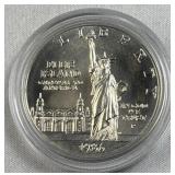 1986 Silver Uncirc. Dollar, Ellis Island Comm. 90%