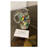 Glass pitcher full of vintage marbles Glass pitcher full of vintage marbles