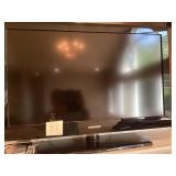 Samsung TV With Stand and Brass Floor Lamp