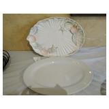 Two platters a seashell platter and a white Two platters a seashell platter and a white
