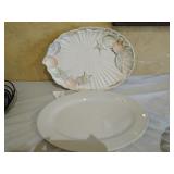 Two platters a seashell platter and a white