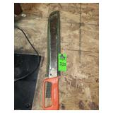 Barteaux & Sons machete with an orange D-handle and a green sheath