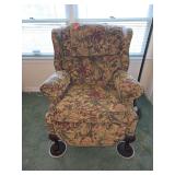 traditional floral-print wingback recliner featuring dark wood ball-and-claw feet