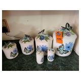 Vintage white ceramic canister featuring 3D embossed blue flowers and a detailed butterfly on the lid.