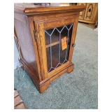 Solid wood end table featuring a distinctive leaded glass door.