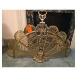 vintage ornate brass folding fan fireplace screen featuring intricately pierced metal blades