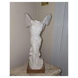 cast marble replica of the Winged Victory of Samothrace (also known as the Nike of Samothrace) mounted on a wooden base.
