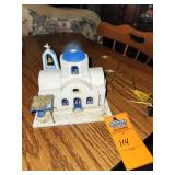 Handmade or ceramic architectural model resembling a traditional Greek island church