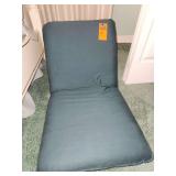 Adjustable folding floor chair with back support.