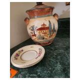 Hand-painted ceramic Tuscan-style cookie jar featuring a charming Italian villa scene and tall cypress trees.