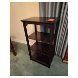 Dark mahogany open-shelf end table featuring multiple display tiers and subtle arched cutout details near the top.