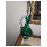 vintage hand-blown emerald green glass ewer decanter featuring a clear applied handle and a textured glass stopper.