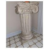 antique-style decorative Roman or Greek Ionic column pedestal with a fluted shaft and scroll capital finish.