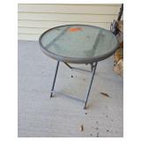 Small round glass topped patio table