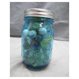 Blue Ball Jar Filled With Colorful Marbles