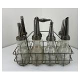 Group of 7 Embossed Oil Bottles and Carrier