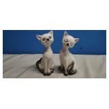 Two Siamese cat figurines