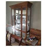 oak curio cabinet with a lighted interior and
