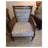 wood armchair with cane side panels and a floral