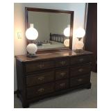 dark wood nine-drawer dresser paired with a