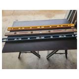 Three Level Tools Including Yellow Plastic, Wooden, and Blue Aluminum Models