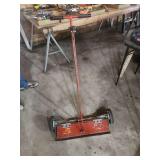 Red Push Lawn Spreader with Dual Pneumatic Tires and Hinged Hopper