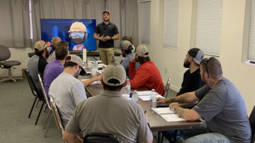 Jordan Davis, Senior Manager of Business Development & Training for RailPros holds a safety meeting.