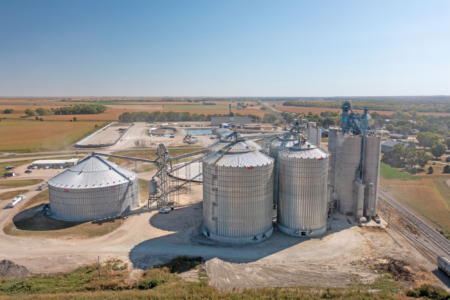 Four new Chief Agri steel tanks (center), two at 800,000 bushels each and two at 415,000 bushels each, at Ag Valley Coop in Edison, NE. Photo taken by Monster Media.