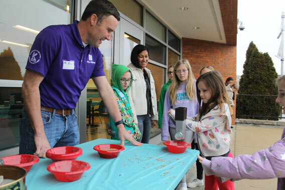 IAOM Board Member Eric Knott, Miller Milling, and Dana Edwards, Ardent Mills, show the youngest of the Flour Rangers how wheat is transformed into flour. Photo courtesy of the Girl Scouts of Eastern Missouri.