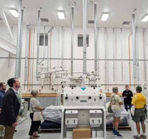 Visitors tour the new lab milling room that is part of the Peltier Complex.
