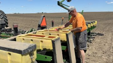 Beck's grower Kent Baker applies talc powder as he prepares to plant seed corn May 29 near Mount Pleasant, IA. The powder helps the seed flow through the planter. (Chris Lusvardi photos)