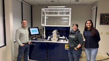 From left to right, Jim Schweigert, president; Meck Slagle, vegetable seed improvement lead; and Khushi Chawda, market development intern, standing in front of the Seed-X machine at the new Davis location.