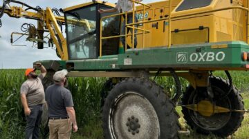 The Beck’s team frequently stops to check crop conditions and the progress of the work being done such as detasseling. (Chris Lusvardi)