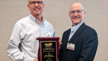 Mac Erhardt receives the MCIA Achievement in Crop Improvement Award from Kevin Schulz at the Annual Meeting of the Minnesota Crop Improvement Association January 29 in St. Cloud, MN. (Photo by Alan Makinen, Minnesota Crop Improvement Association)